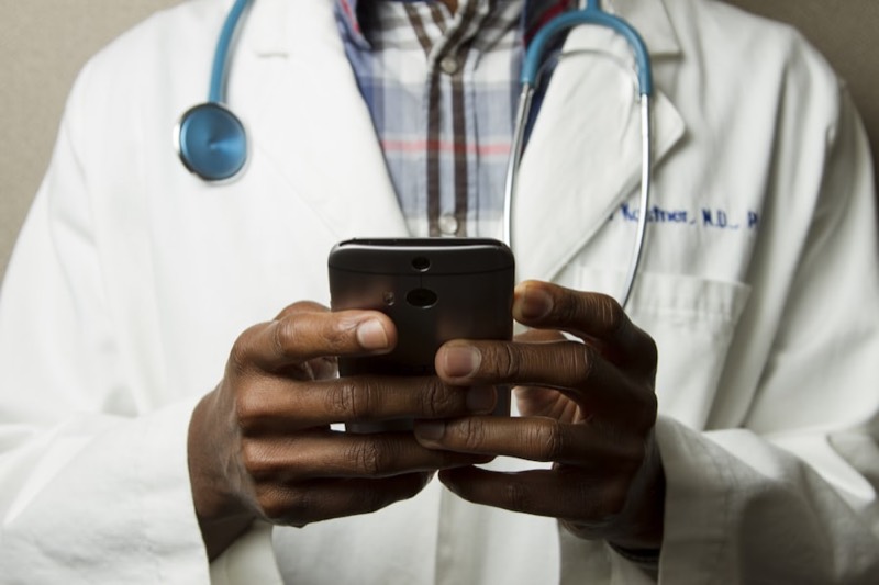 Physician using a phone for a virtual care visit